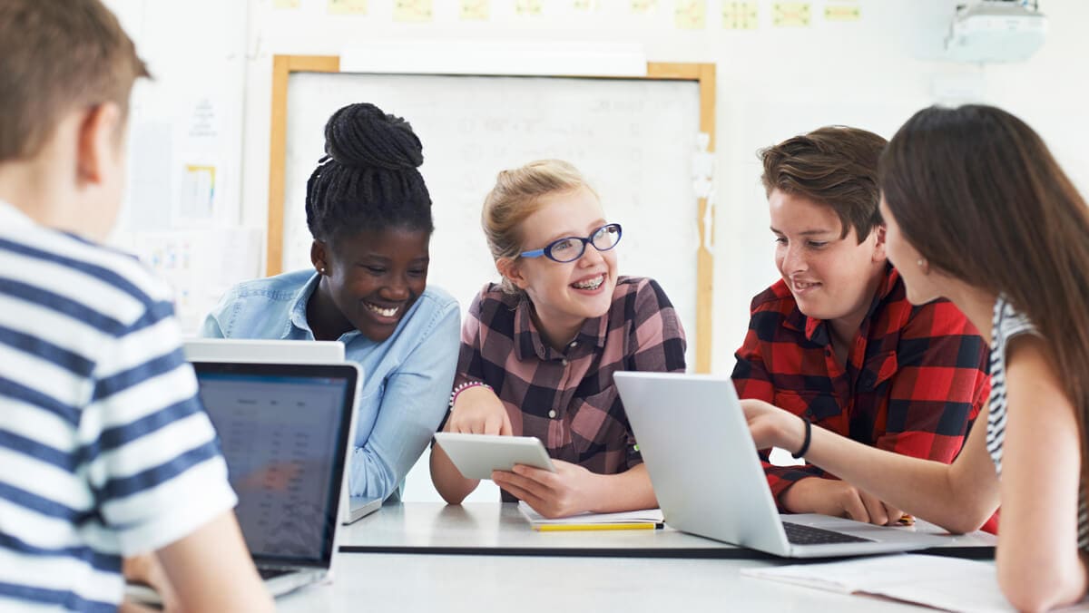 Students using laptops in classroom